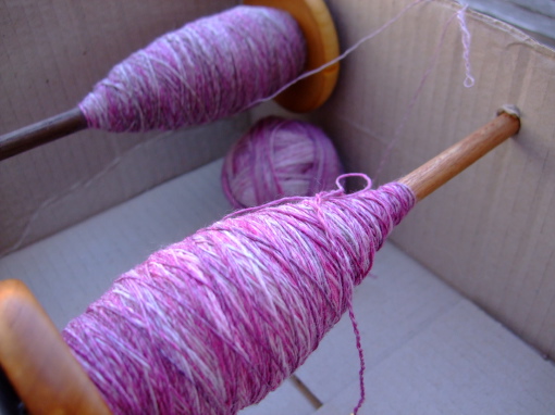 Winding singles of two full spindles into a plying ball.